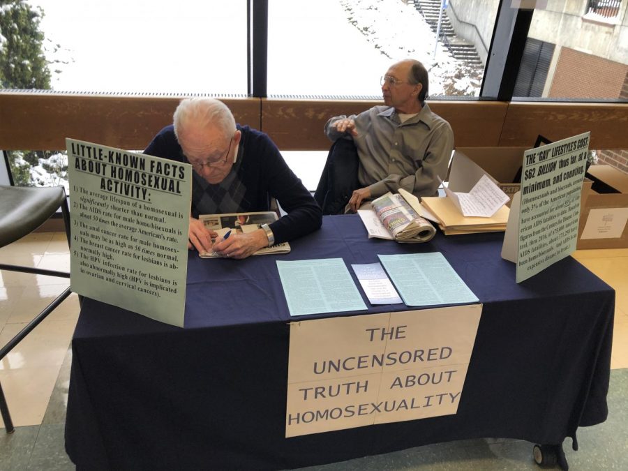 John McCartney (left) and Wayne Lela (right),  are representatives of anti-LGBT group H.O.M.E.  They said the group has been visiting Harper's campus for over 10 years. Photo courtesy of Mark D'Adamo. 