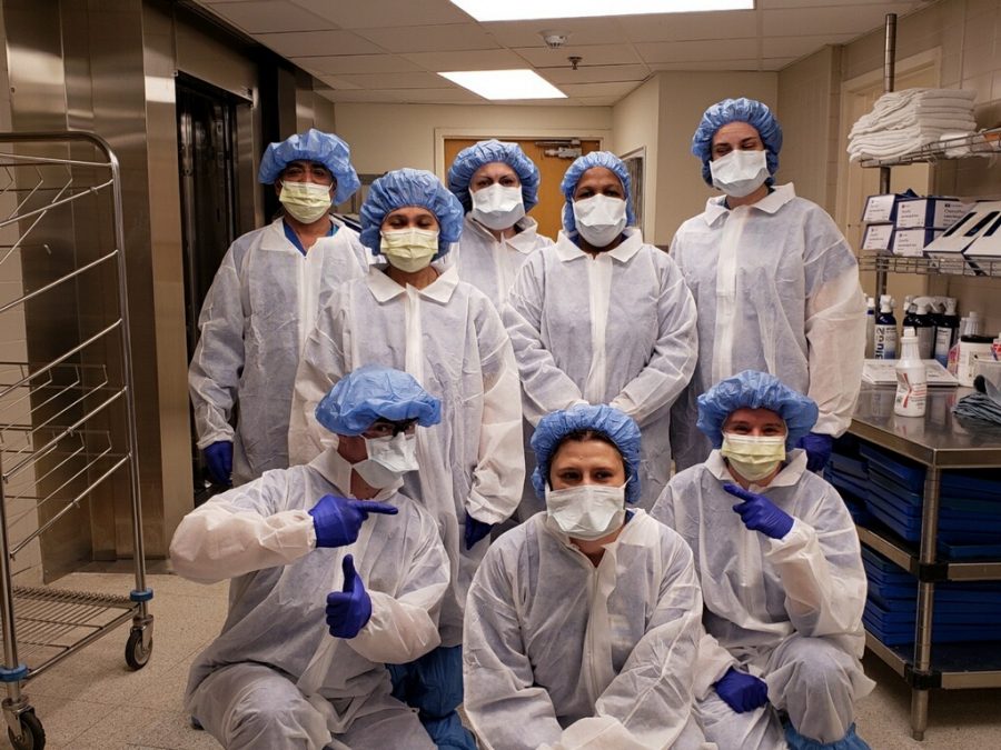 Teresa D’Alesio (center standing) and Central Sterilization Department staff with their new gowns on March 15th, 2020 before the coronavirus hit AMITA Health Alexian Brothers Medical Center in Elk Grove Village, IL. Photo Courtesy of Gianna DAlesio.