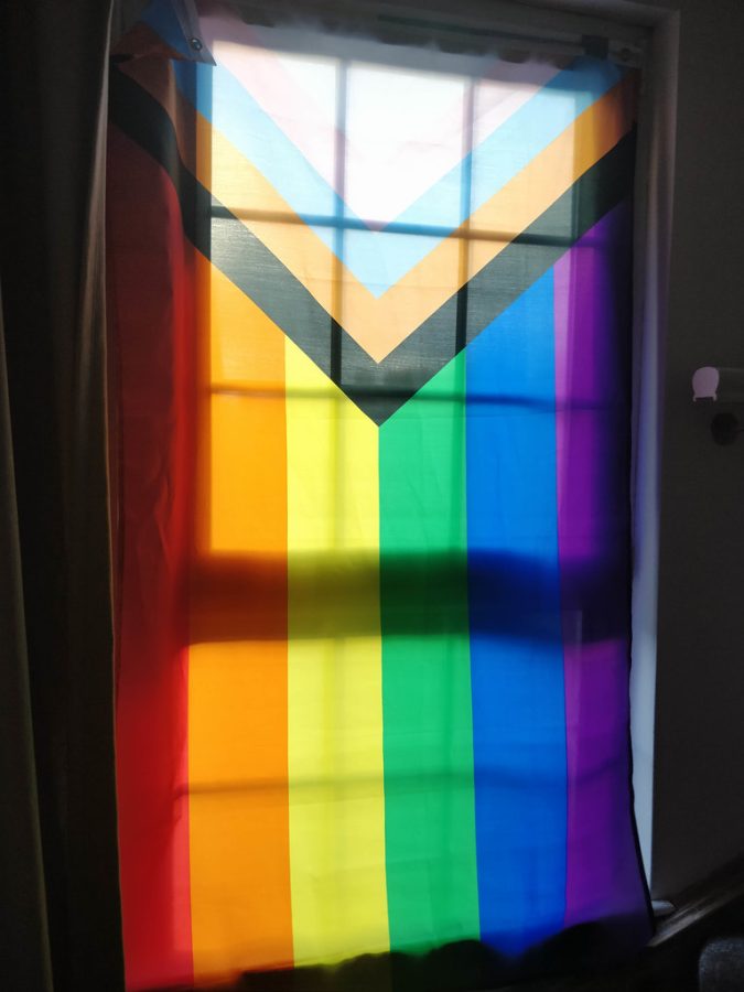 A Progress Pride flag is displayed. (photo courtesy of Creative Commons. Creator: Christine Schmitt).