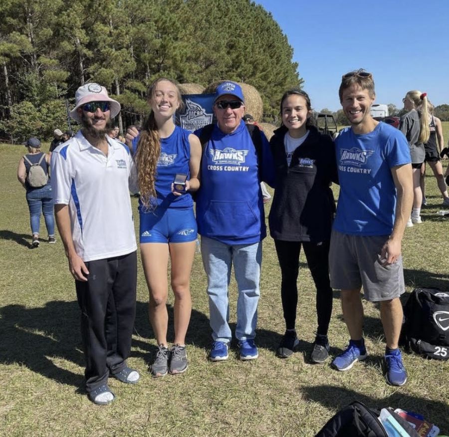 Fiona+Metzo+poses+with+head+coach+Jim+Macnider+and+assistant+coaches+John+Majerus%2C+Eric+Waller+and+Diane+after+winning+All-American+at+Milledgeville%2C+GA+on+November+13%2C+2021.+Photo+courtesy+of+Harper%E2%80%99s+Cross+Country+team.%0A%0A