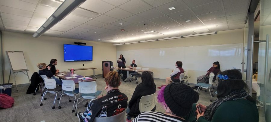 Guest judge Professor Murali shares one of her poems with student performers at a poetry slam in the Multicultural Center organized by Pride Club on April 6, 2022. (Photo by Ari McKellin.)