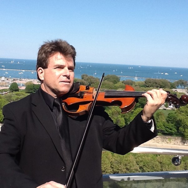 Music instructor and professional violinist Edgar Gabriel poses with his instrument.  (Photo courtesy of Harper College)