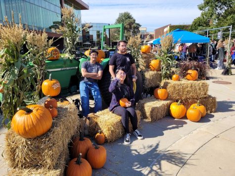 Students celebrate autumn by posing with pumpkins in Harpers quad. This years Fall Fest is the second in the events history, and was organized by the Student Activities Board and Student Engagement. (Photo by Cole Altmayer)