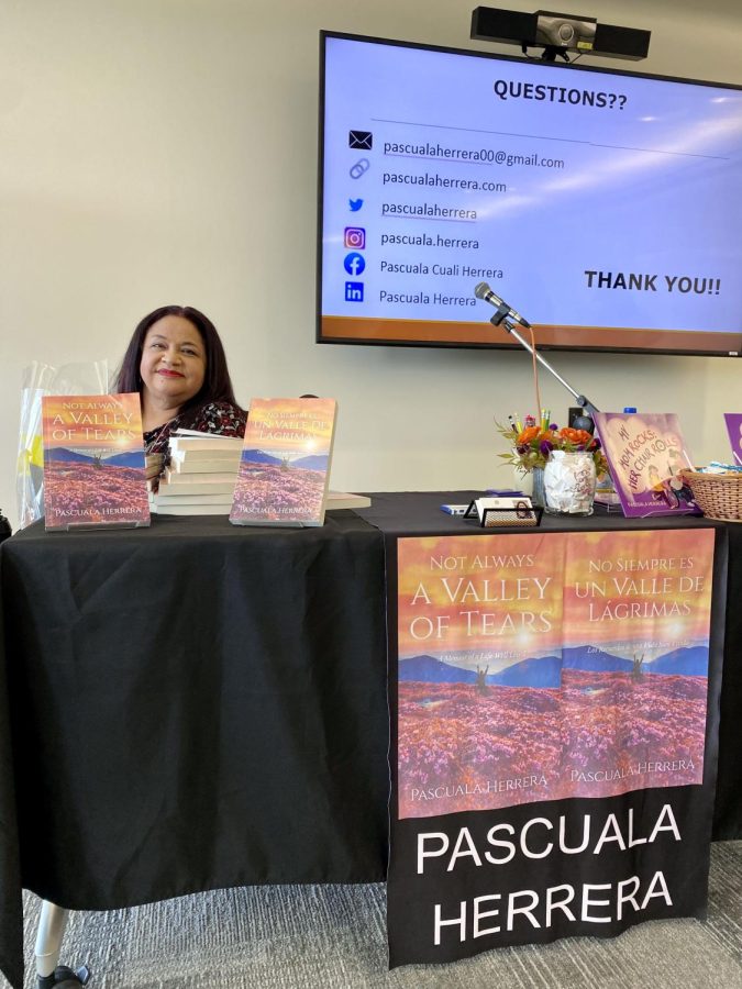 “Not Always a Valley of Tears” author and former Harper professor Pascuala Herrera poses with her memoir after a presentation in the Cultural Center on October 13. Herrera is an advocate for LatinX communities and people with disabilities, as well as the co-founder of Educators 4 Equity and Justice. (Photo by Lydia Schultz)