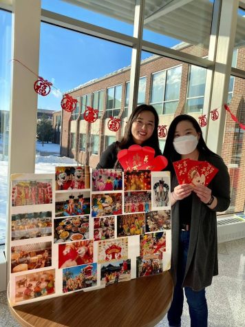 With red envelopes in hand, two students pose for a photo during a student-run Lunar New Year celebration in Harpers Building D. (Photo by Lydia Schultz)