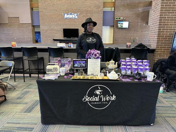 Entrepreneur and founder of Social Work Sunday Tea Shakea Houston smiles proudly behind her table, with all of her teas on display. (Photo by Bridgette Fraga)