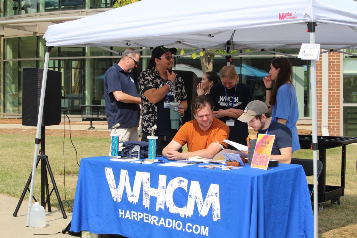 WHCM working work at their booth on Sept. 10, 2024. (photo by Kate Gjoni)