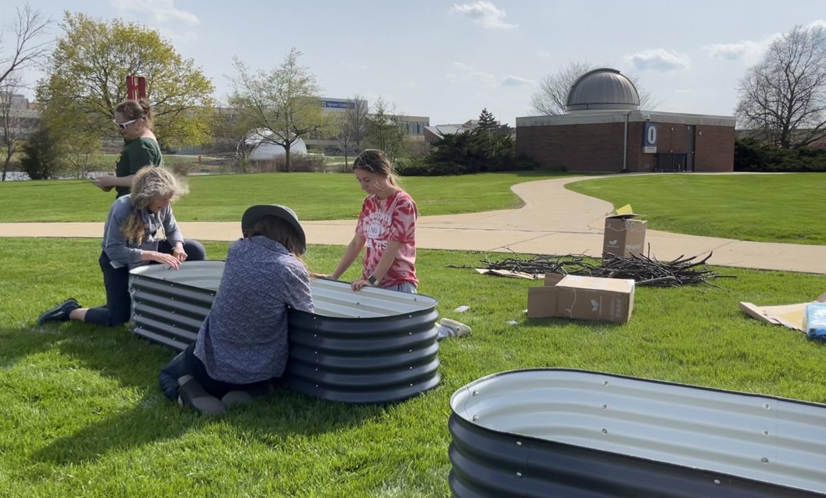 Harper students, faculty, staff, and community members building the Community Garden beds near the Observatory on April 28th. (Photo by Tori Malek)