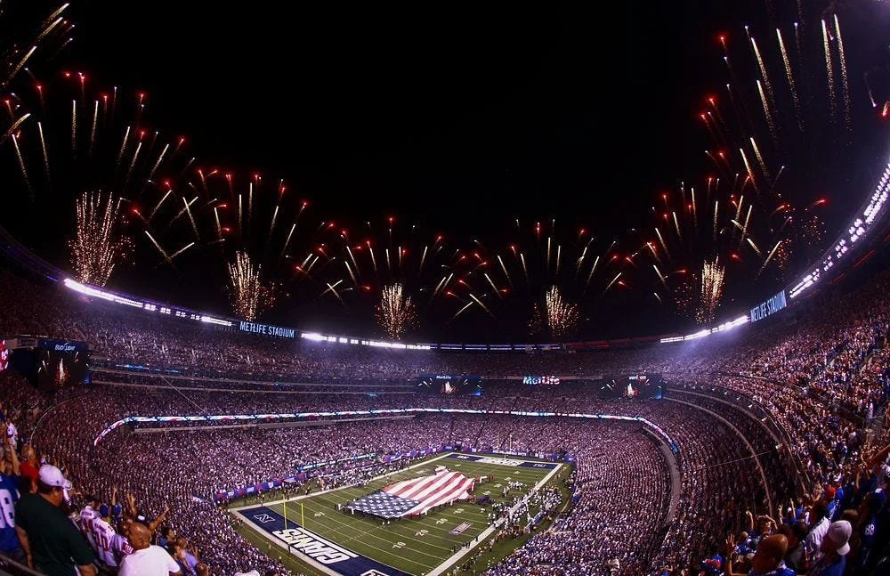 U.S. Marines, Sailors, Coast Guardsmen, Airmen and Soldiers unfurl an American flag across the field at MetLife Stadium, East Rutherford, N.J., Sept. 5, 2012, during a pre-game ceremony before the New York Giants versus Dallas Cowboys football game. Photo courtesy of Raw Pixel.